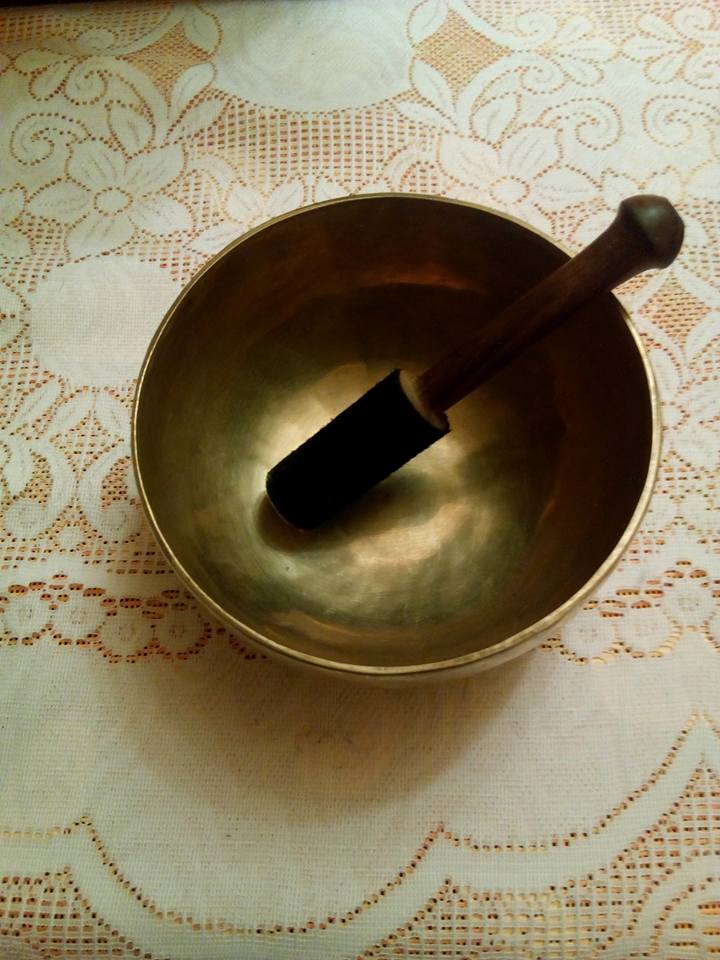 Singing Bowl & Strker on a lace table cloth