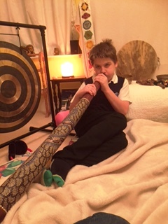 12 year old with digeridoo at his sound healing session